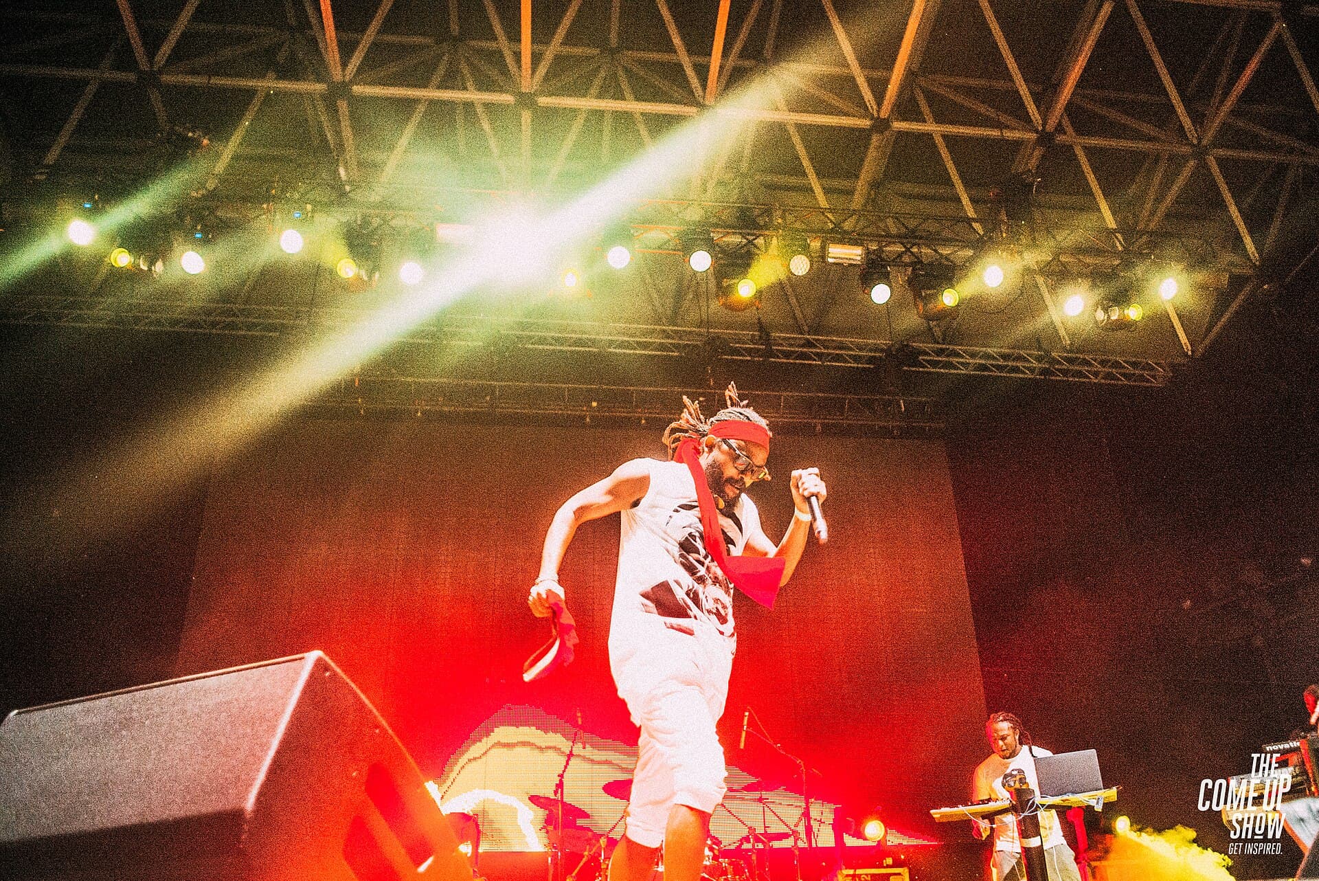 Machel Montano performing on a festival stage under bright yellow and red stage lights at OVO Fest 2017 in Toronto